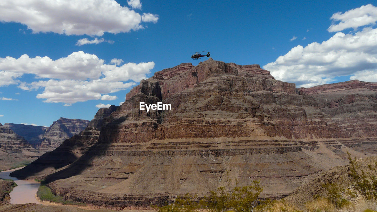 Low angle view of mountain against cloudy sky
