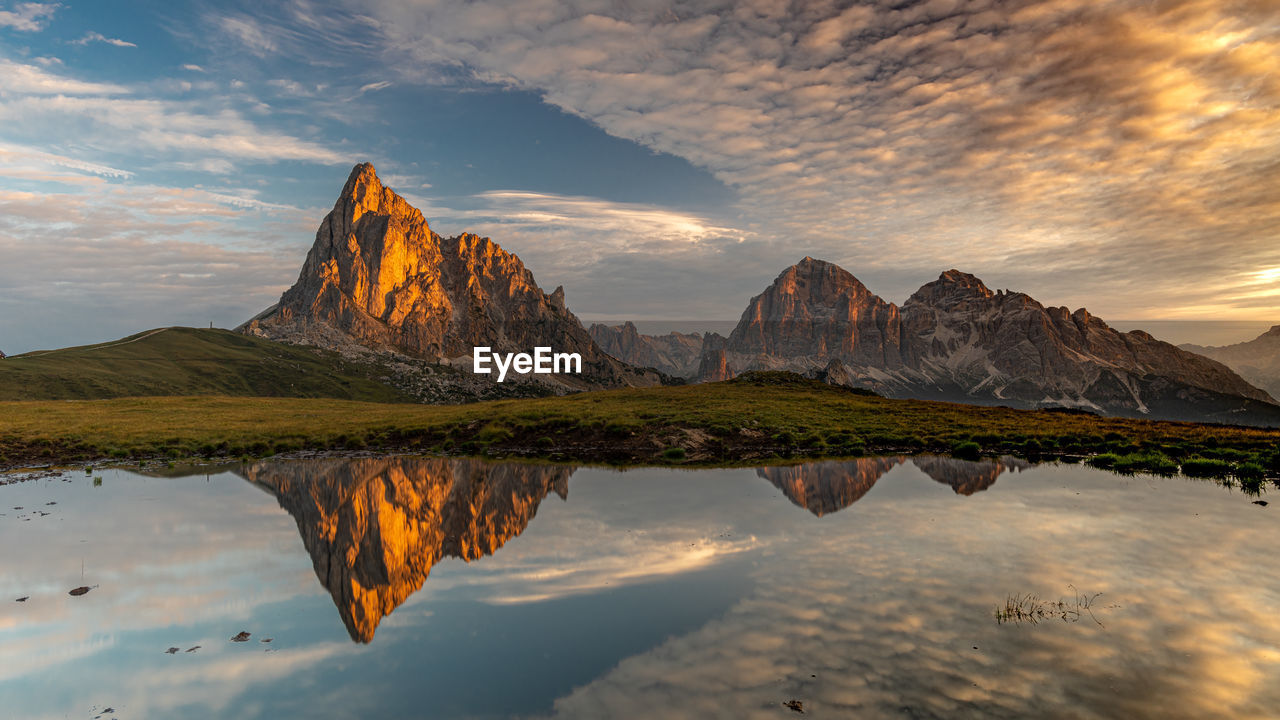 Scenic view of lake by mountain against sky