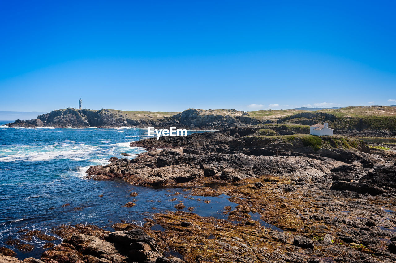 Scenic view of sea against clear blue sky