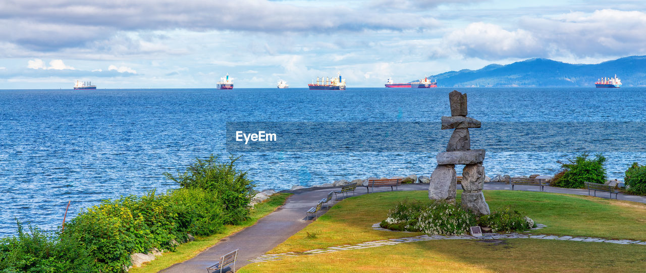 scenic view of sea and mountains against sky