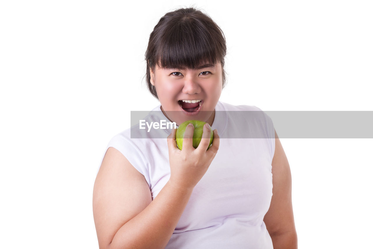 PORTRAIT OF SMILING MAN HOLDING APPLE