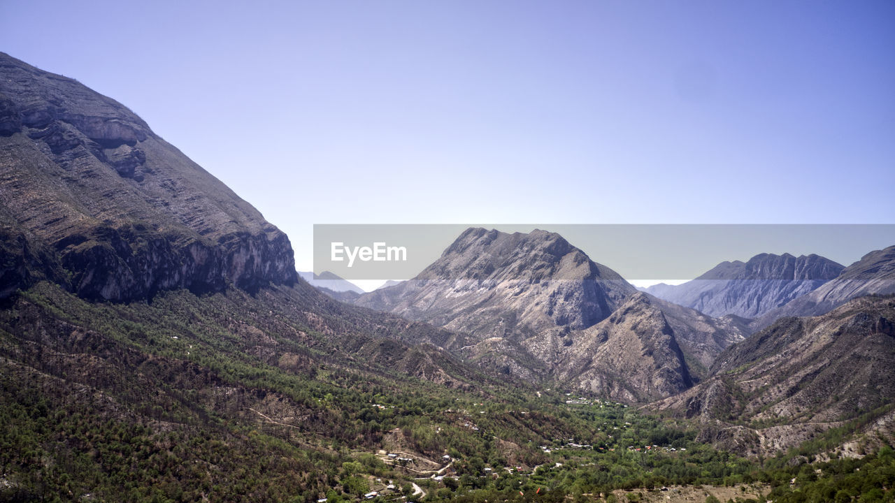 scenic view of mountains against clear blue sky