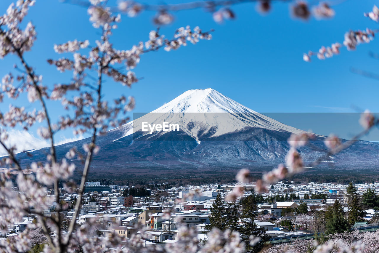 View of cityscape and mt fuji against clear sky