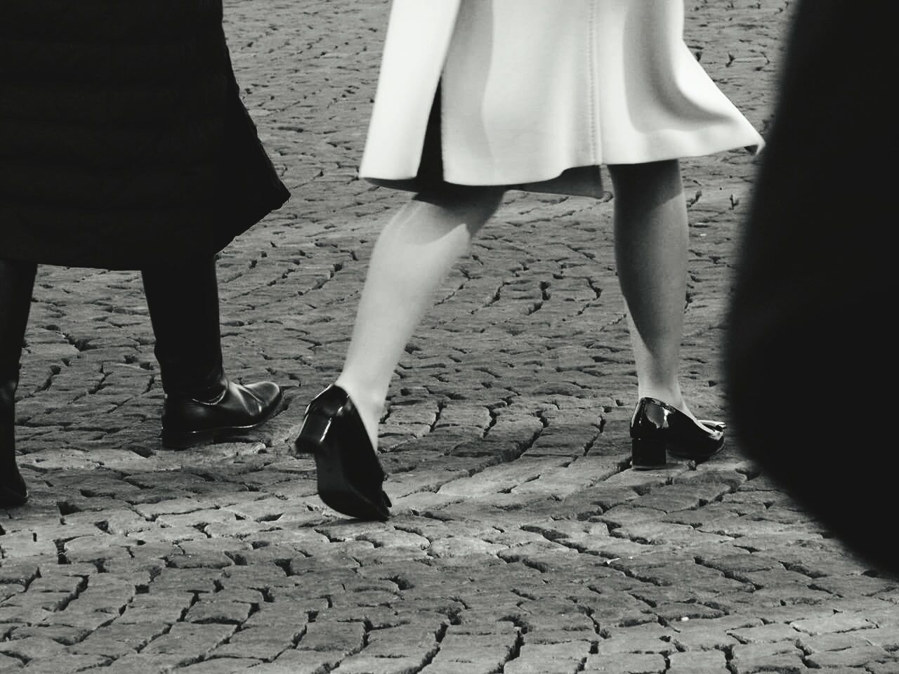 Low section of man and woman walking on street