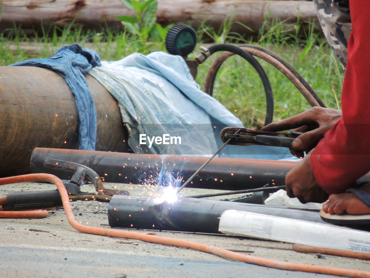 Midsection of welder working at site
