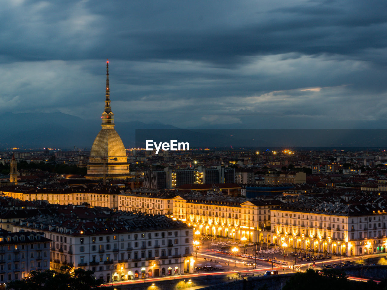 Illuminated cityscape against sky at night