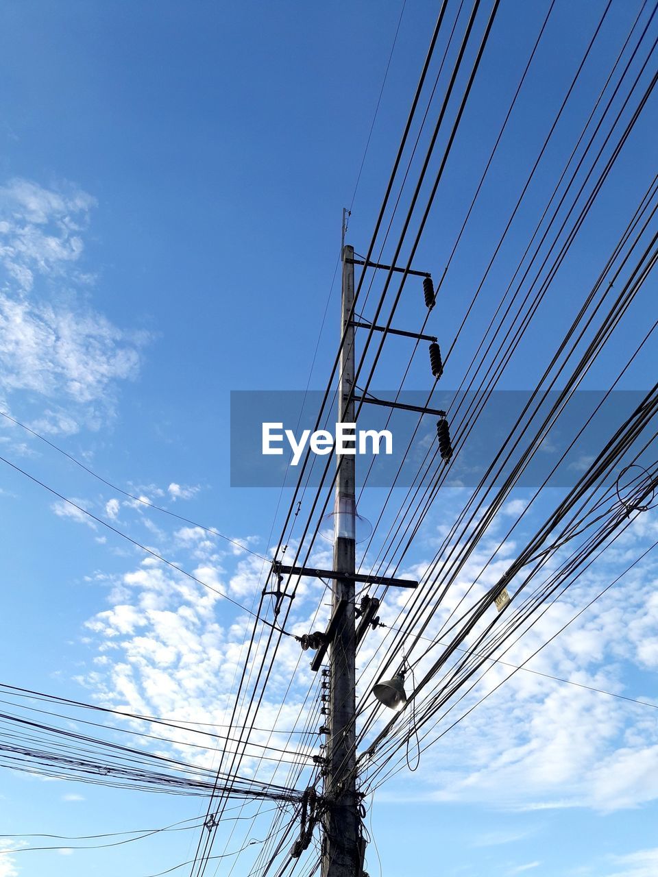 Low angle view of electricity pylon against sky