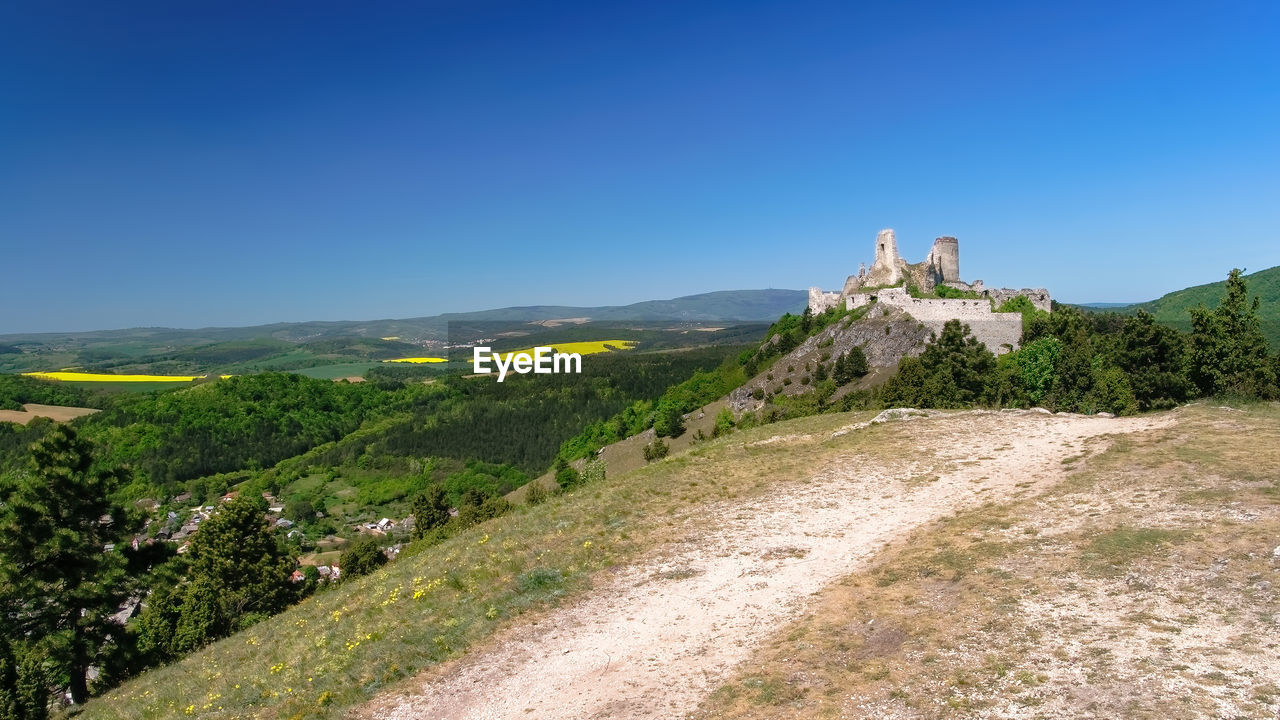 SCENIC VIEW OF LANDSCAPE AGAINST BLUE SKY