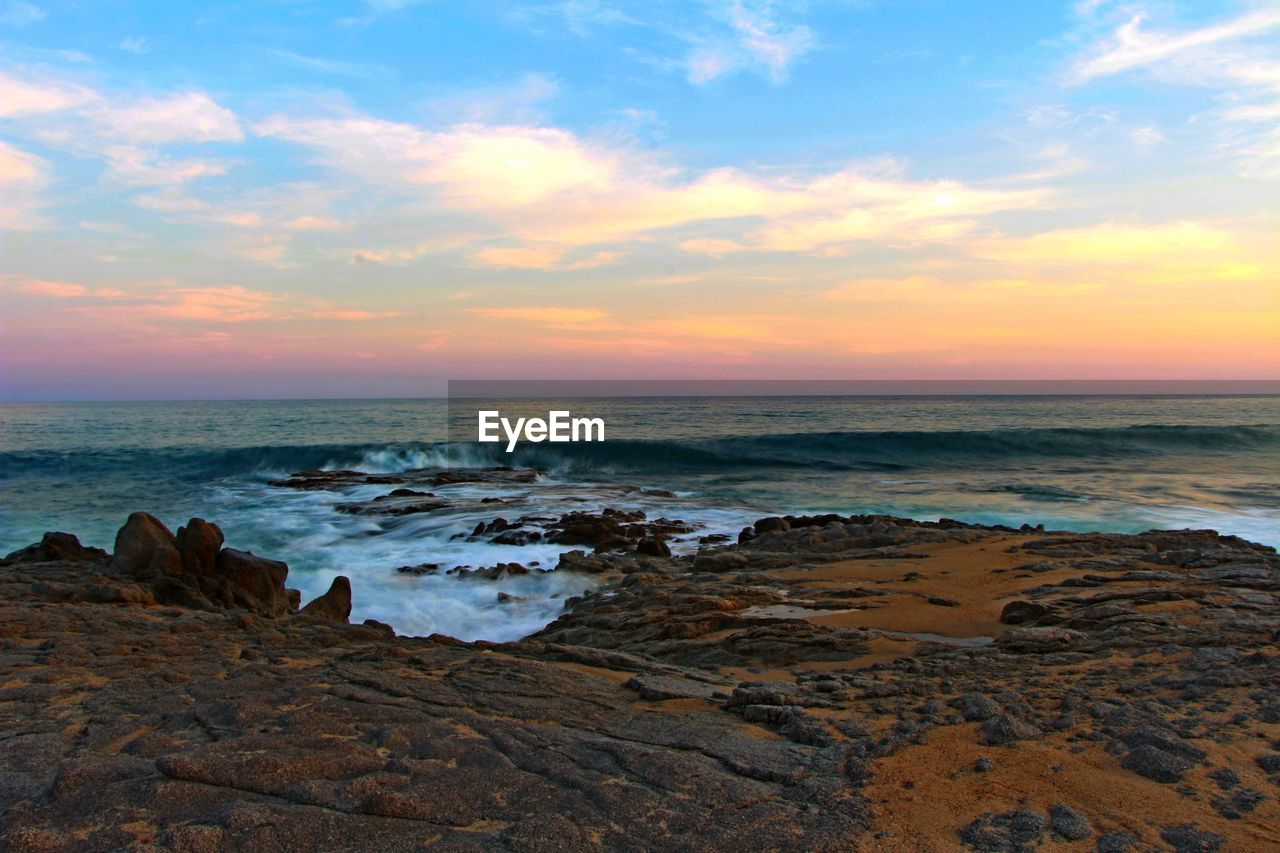 Scenic view of sea against cloudy sky