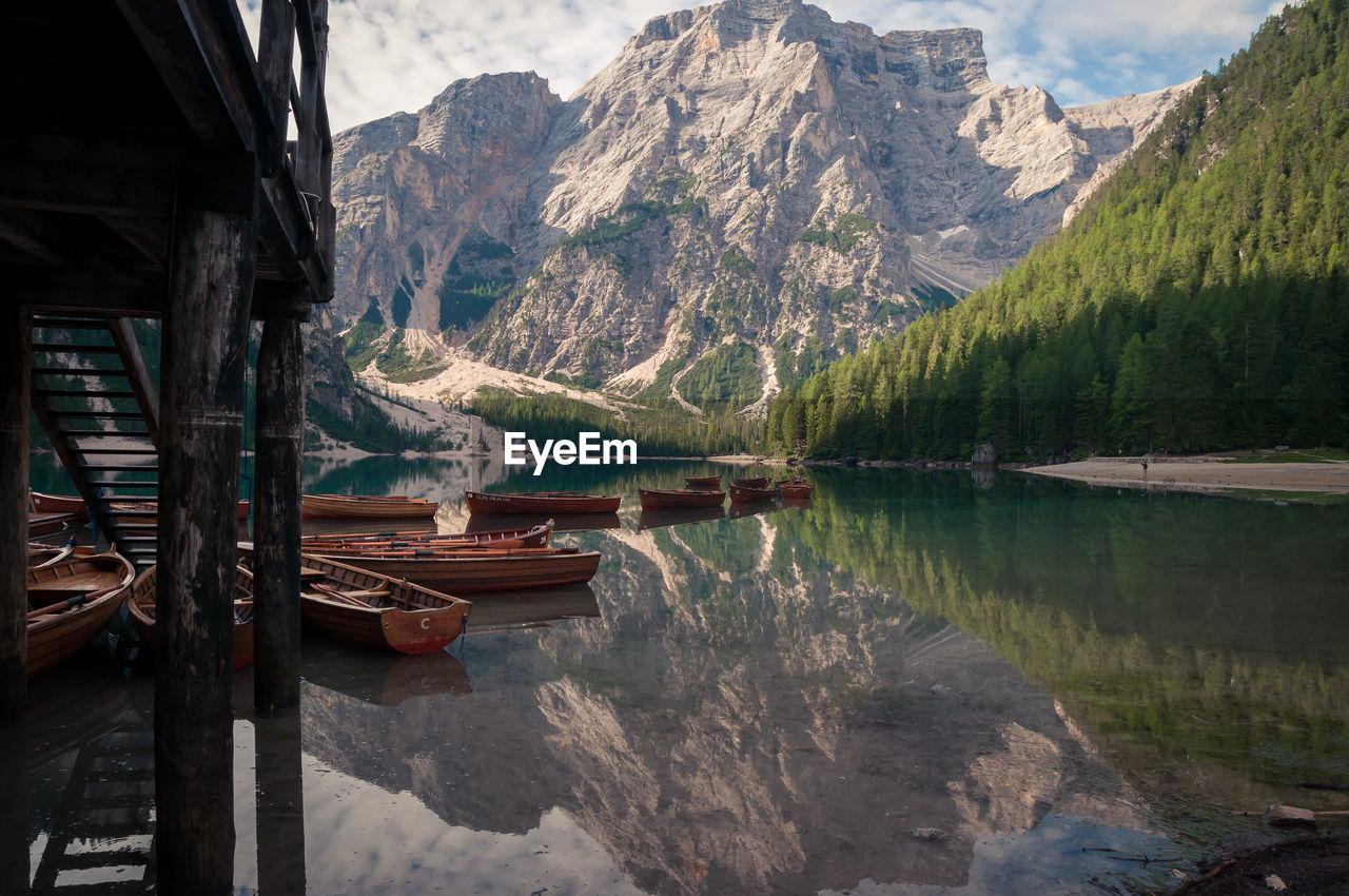 Scenic view of boats in lake against mountains