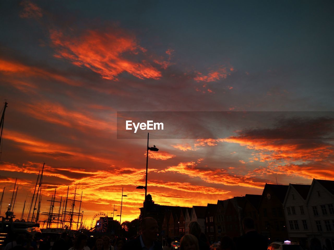 SILHOUETTE BUILDINGS AGAINST DRAMATIC SKY DURING SUNSET