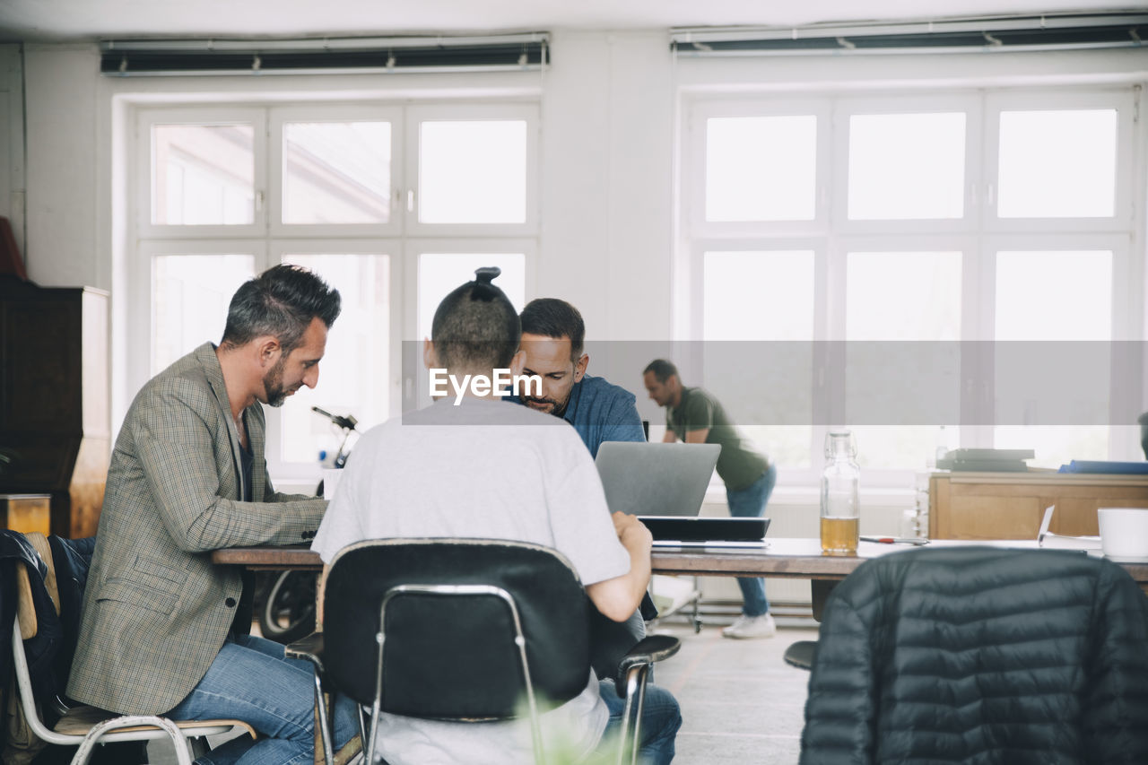 Creative business people working at table in office