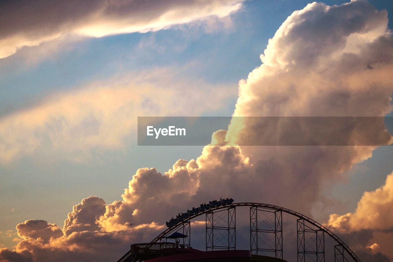 LOW ANGLE VIEW OF ROLLERCOASTER AGAINST SKY