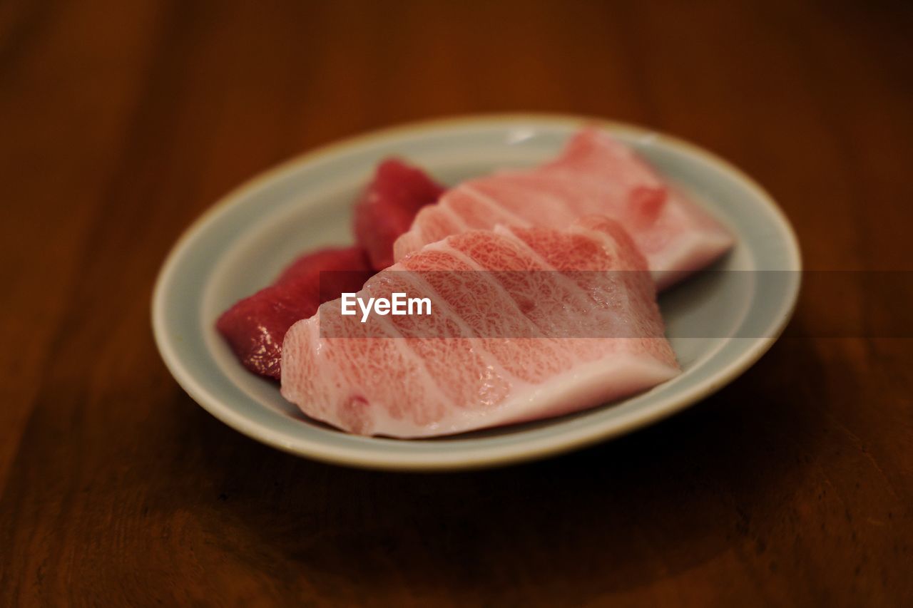 High angle view of tuna sashimi in plate on table