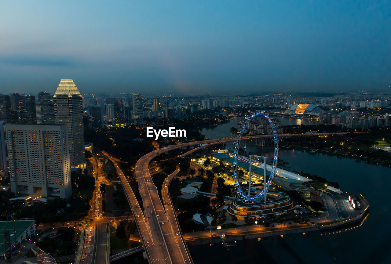 High angle view of city lit up at night