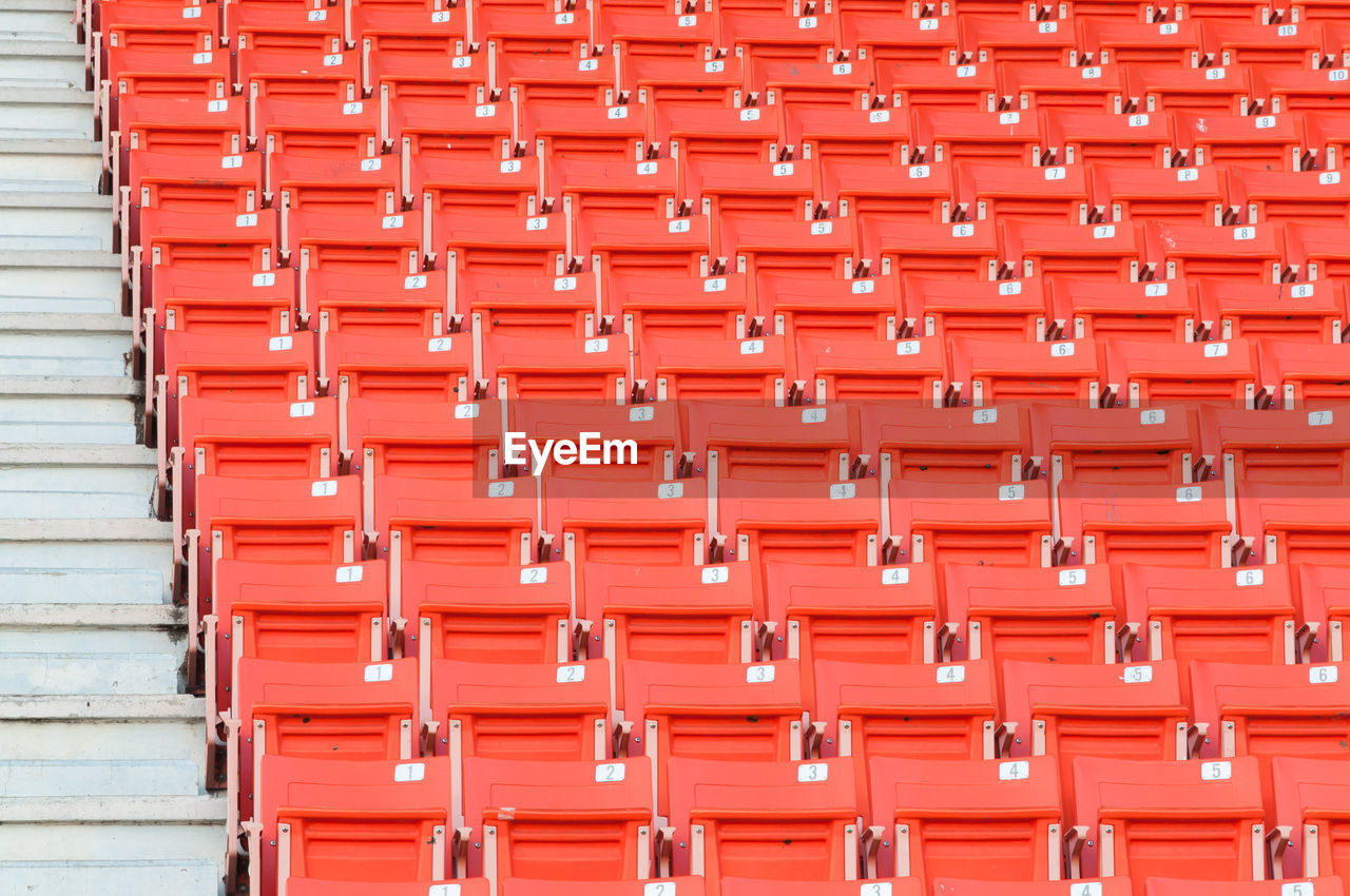 FULL FRAME SHOT OF RED CHAIRS IN STADIUM