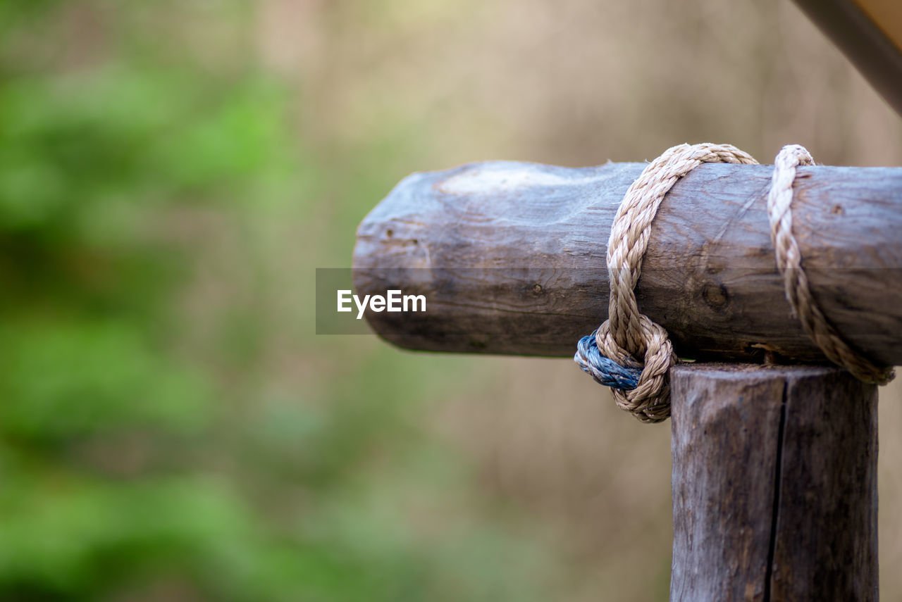 Close-up of rope tied on wooden post