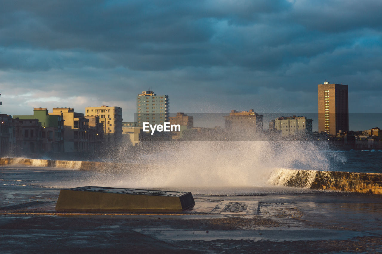 Panoramic view of sea and buildings against sky