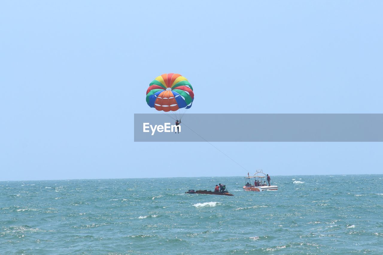 MAN IN SEA AGAINST SKY