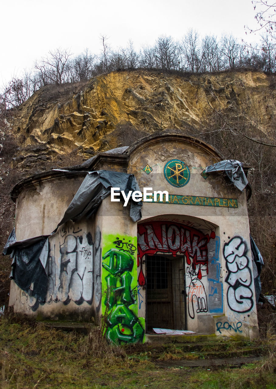 GRAFFITI ON WALL OF ABANDONED HOUSE