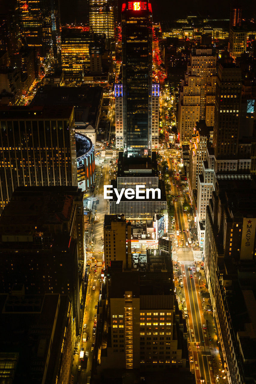 ILLUMINATED MODERN BUILDINGS IN CITY AT NIGHT