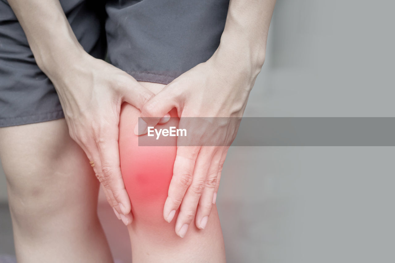 Midsection of person suffering from knee pain