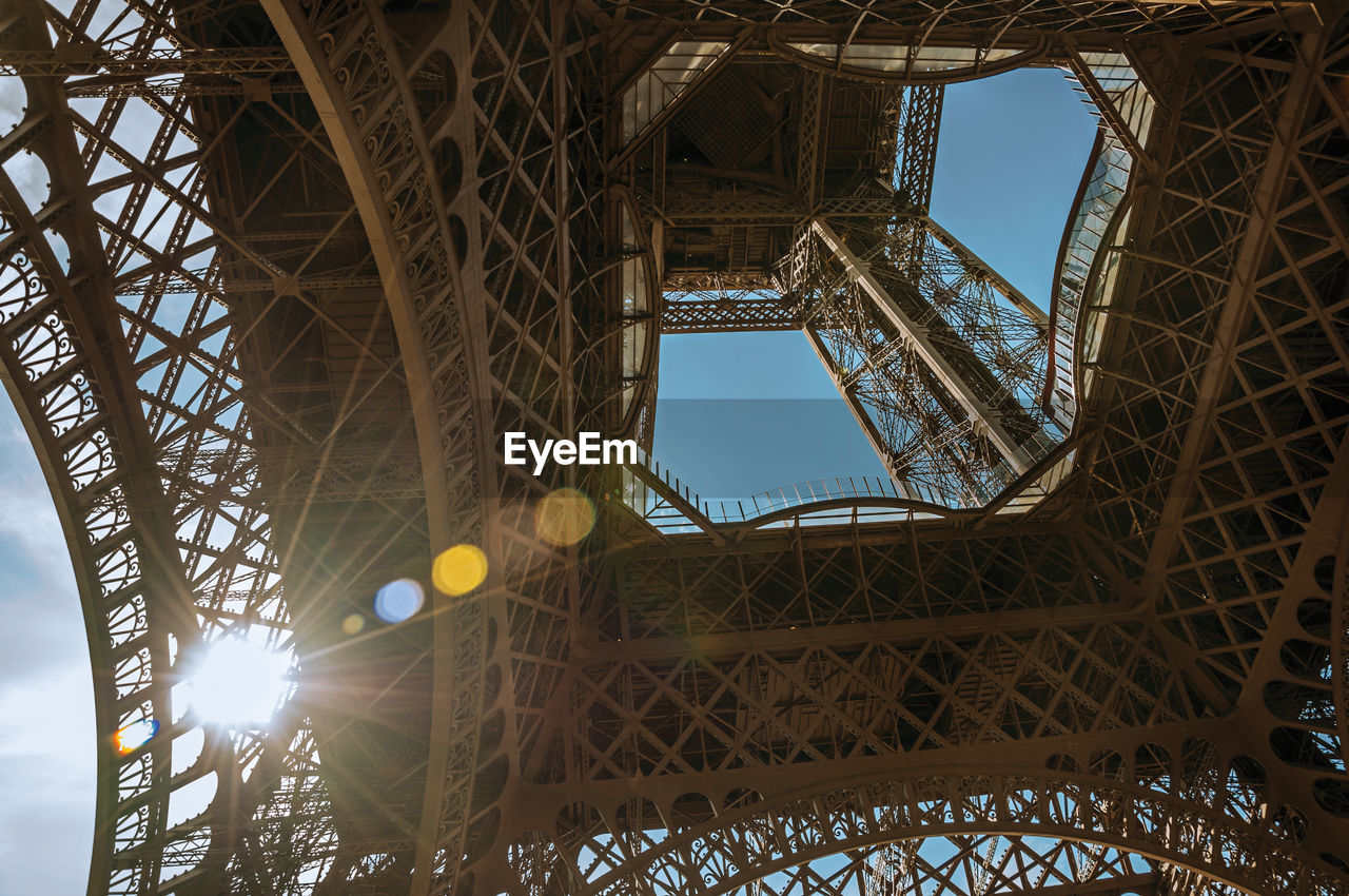 Bottom view of art nouveau style eiffel tower and sunlight in paris. the famous capital of france.