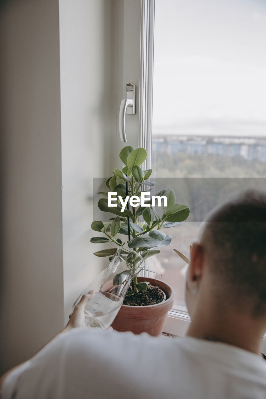 Woman watering potted plants