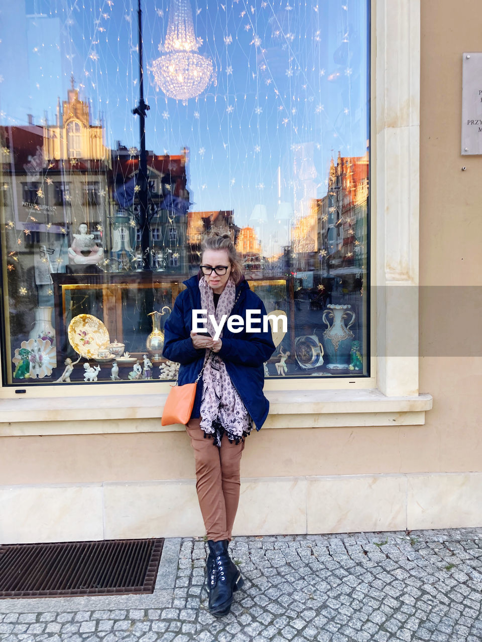 Full length of young woman standing in city