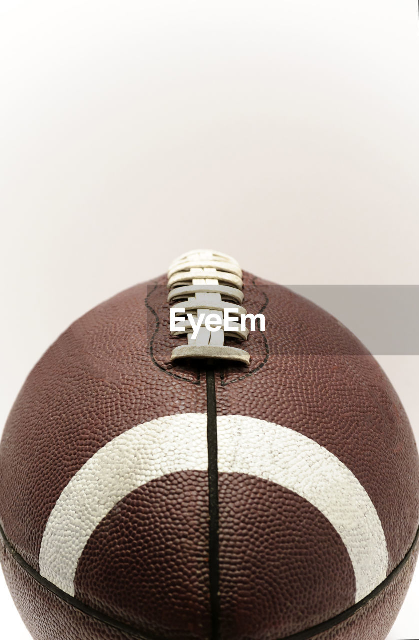 Close-up of rugby ball against white background