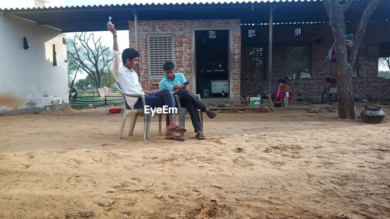 FRIENDS SITTING ON BUILDING AT PARK