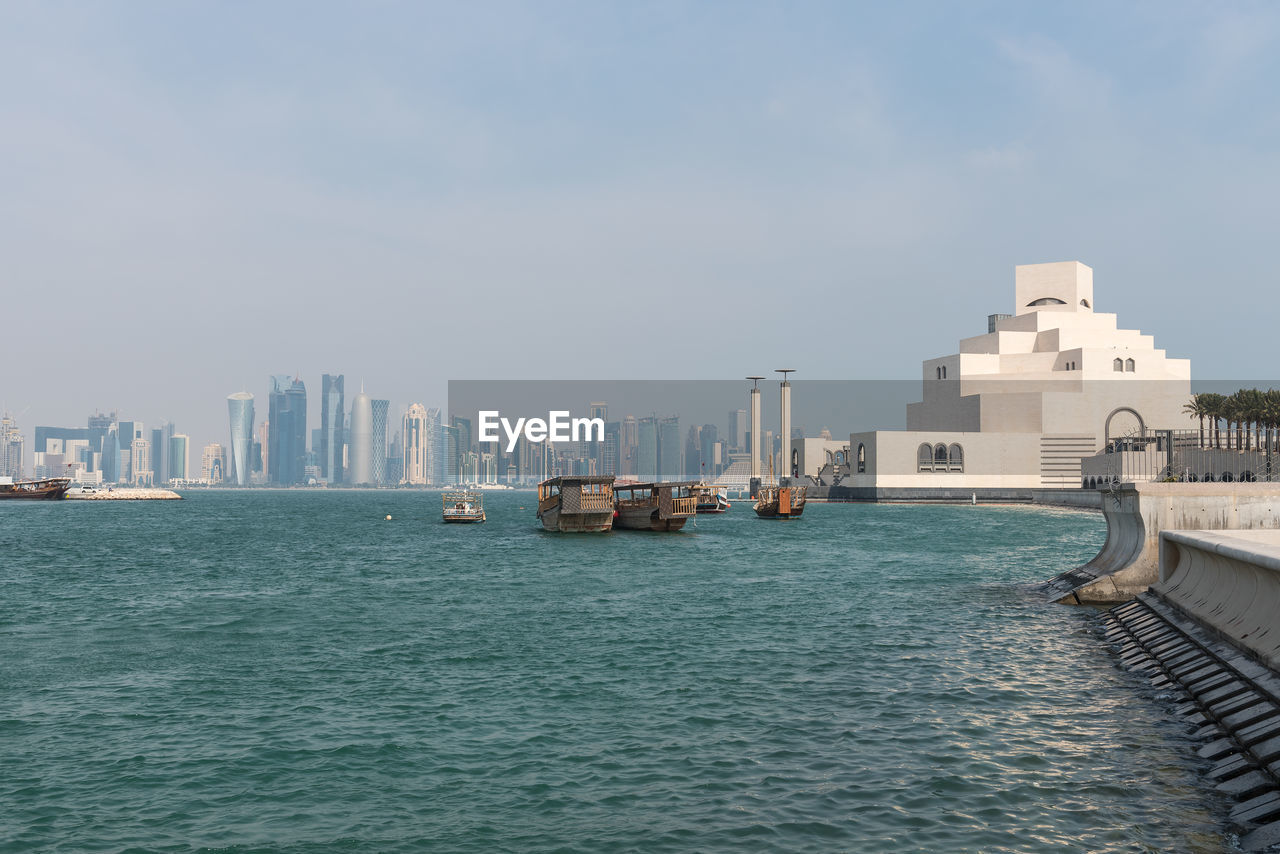 View of sea and cityscape against sky