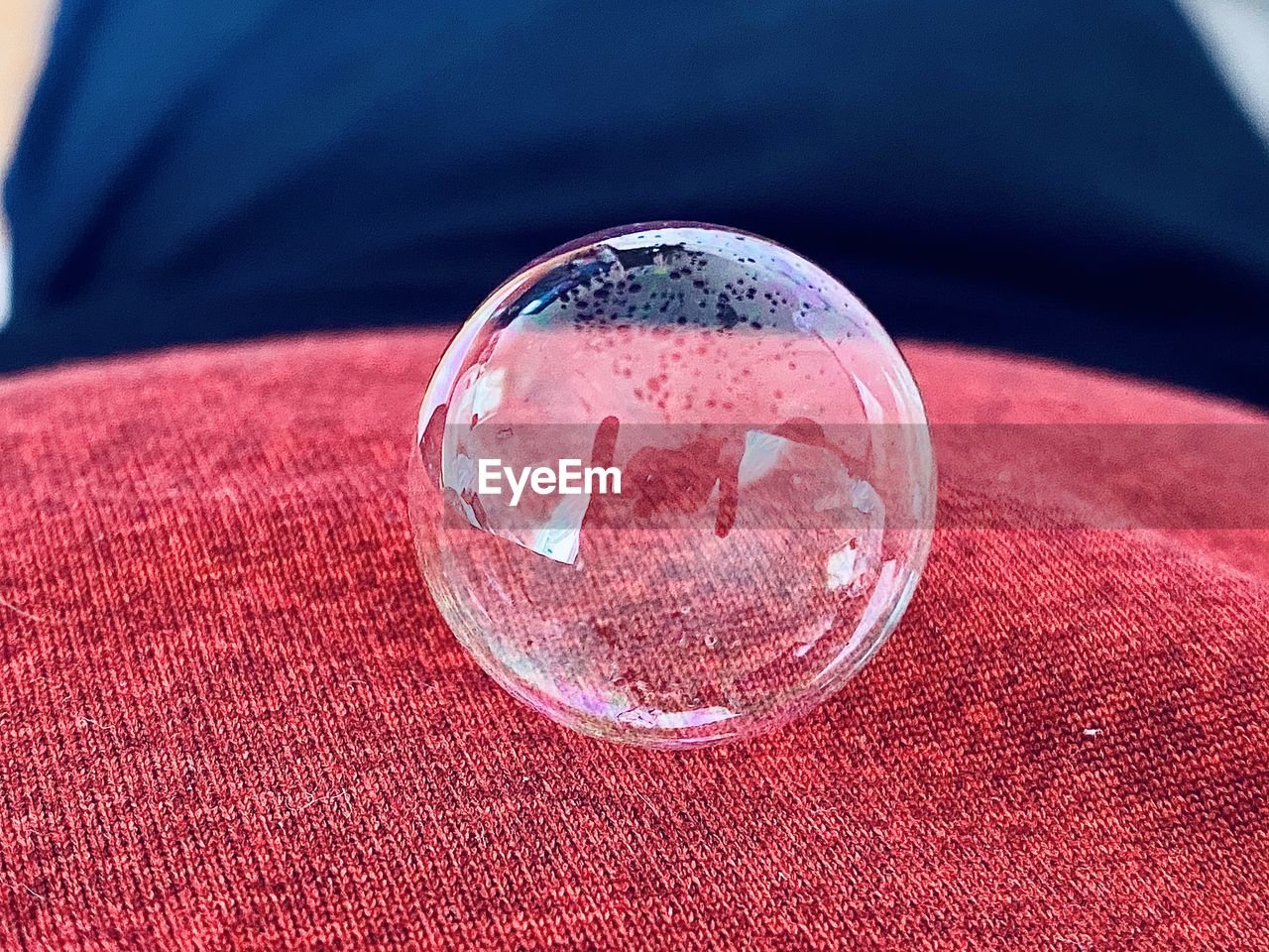 red, sphere, close-up, pink, bubble, shape, transparent, no people, glass, geometric shape, focus on foreground, water, indoors, circle, textile, nature, single object, crystal ball, jewellery