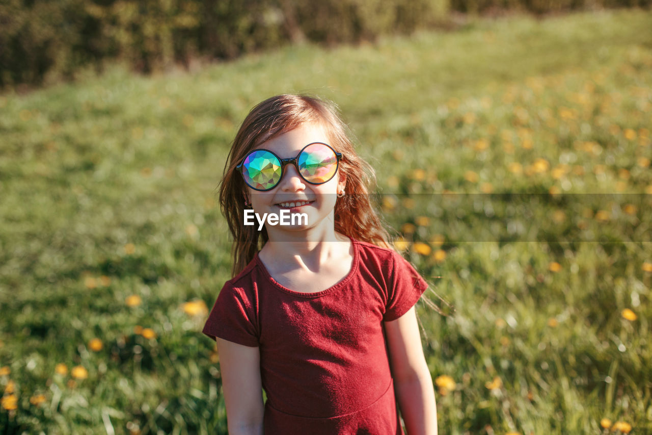 Portrait of smiling girl wearing sunglasses