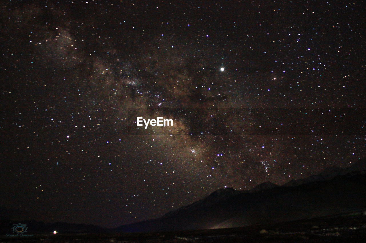 LOW ANGLE VIEW OF STAR FIELD AGAINST SKY