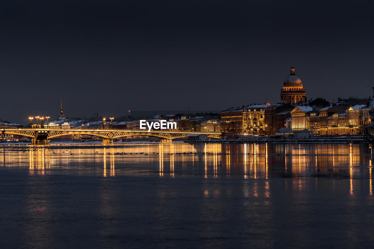 ILLUMINATED BUILDINGS AT WATERFRONT