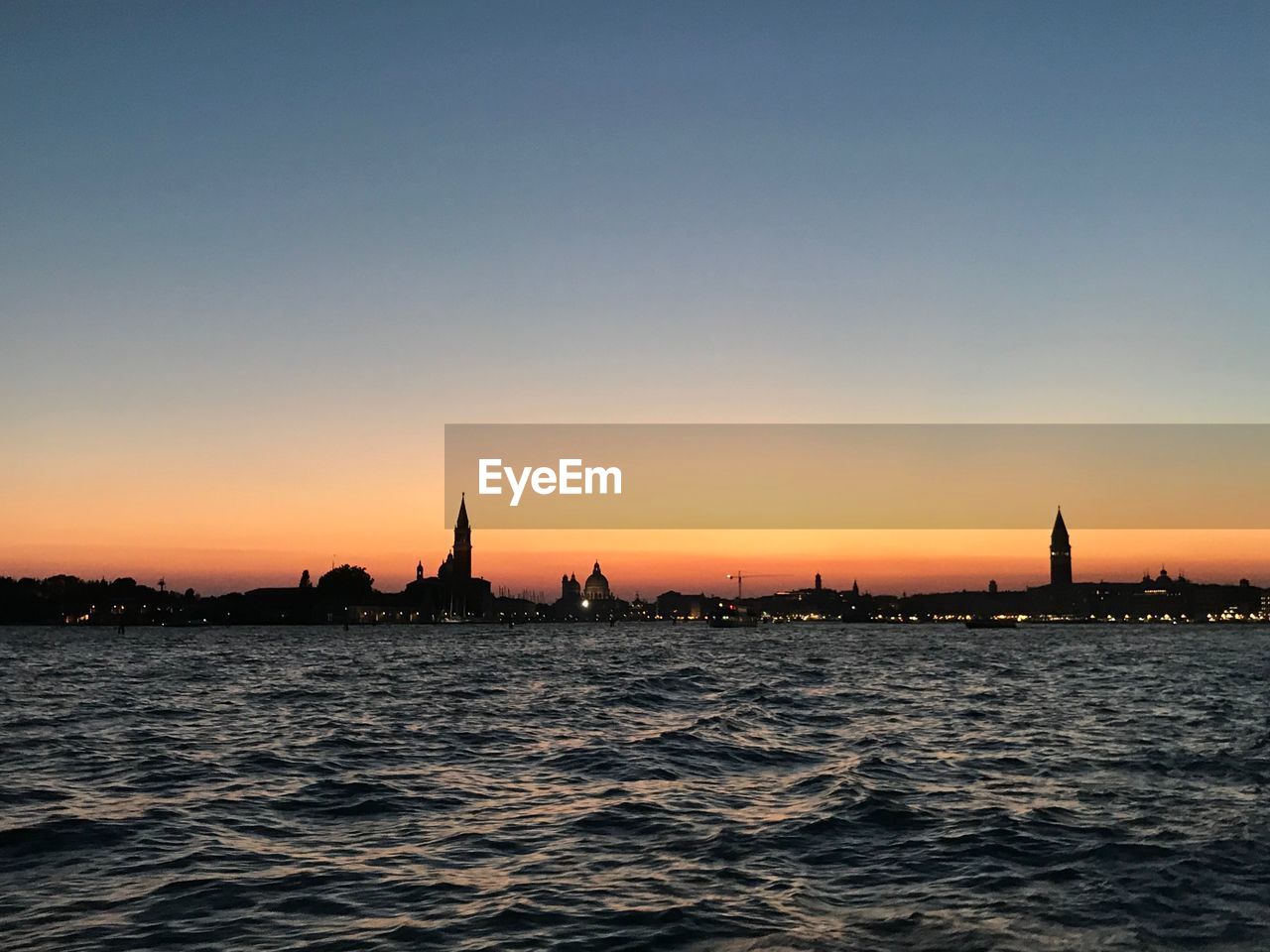 Silhouette of buildings at waterfront