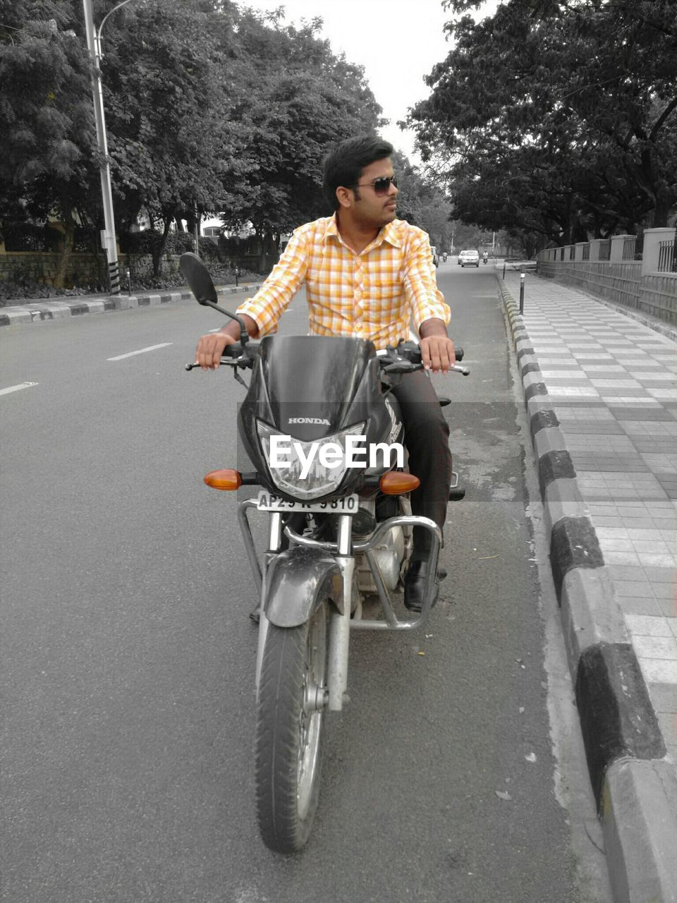 REAR VIEW OF A YOUNG MAN STANDING ON ROAD