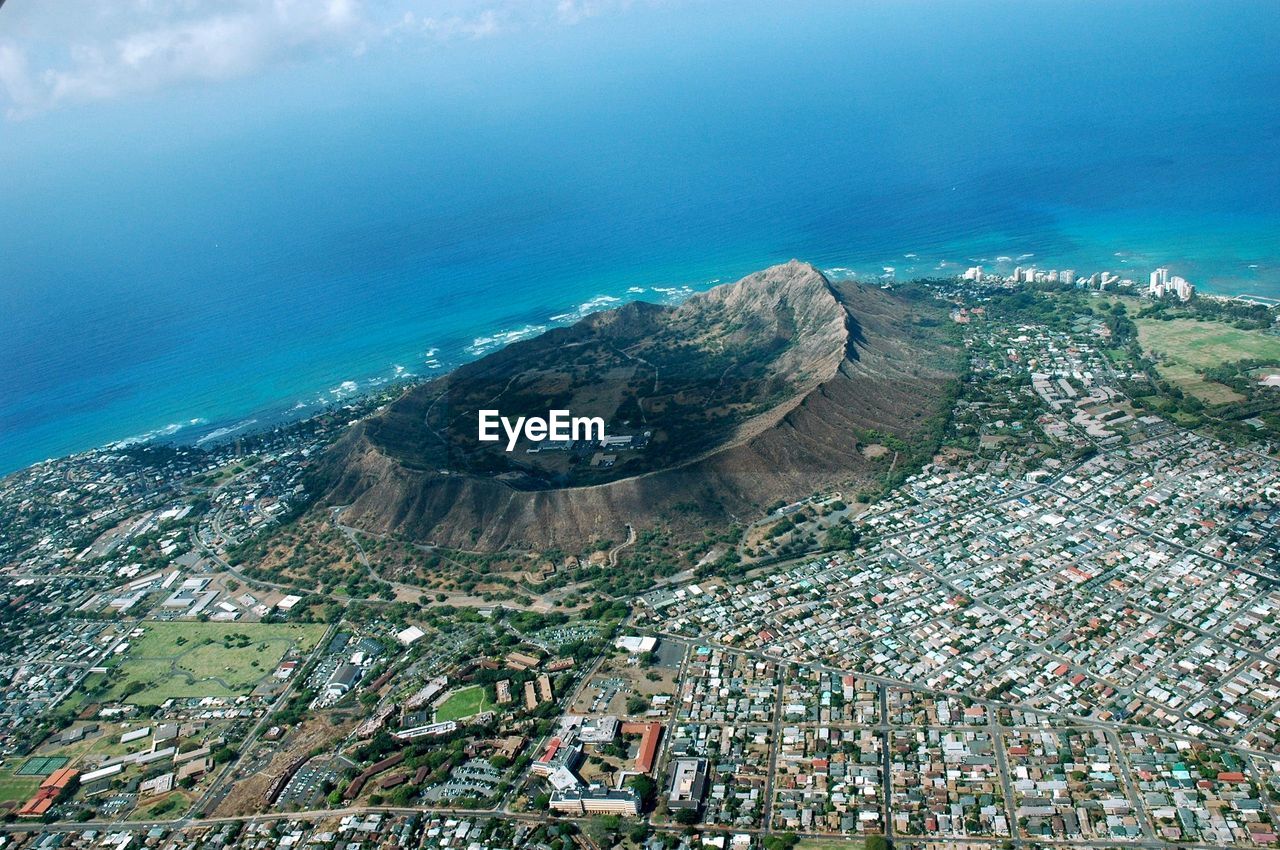 Aerial view of town and mountain by sea