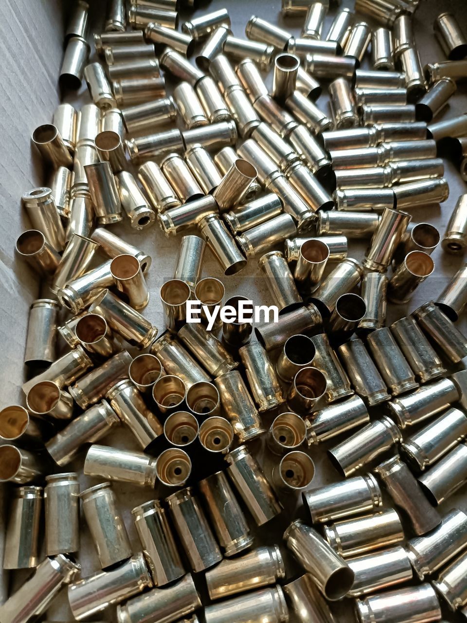 ammunition, metal, firearm, large group of objects, bullet, abundance, indoors, no people, iron, still life, weapon, high angle view, close-up, full frame, backgrounds