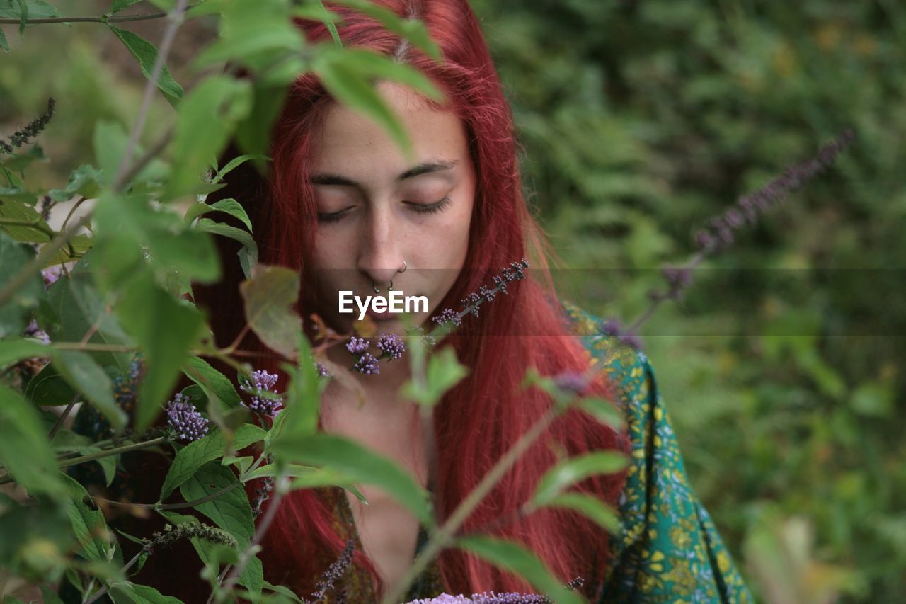 Portrait of young woman standing in a field of lillies