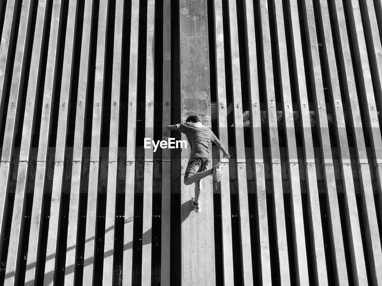 Low angle view of man jumping on wall