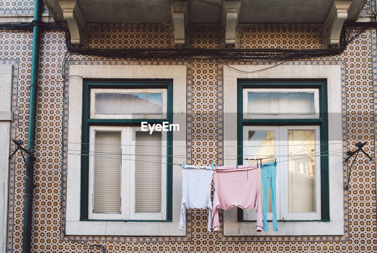 Low angle view of clothes drying outside building