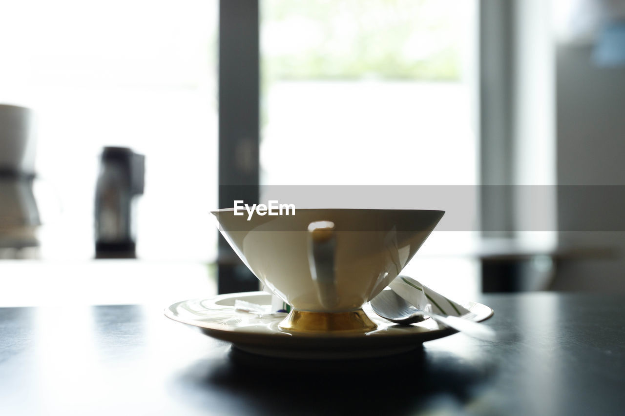 Close-up of coffee cup on table