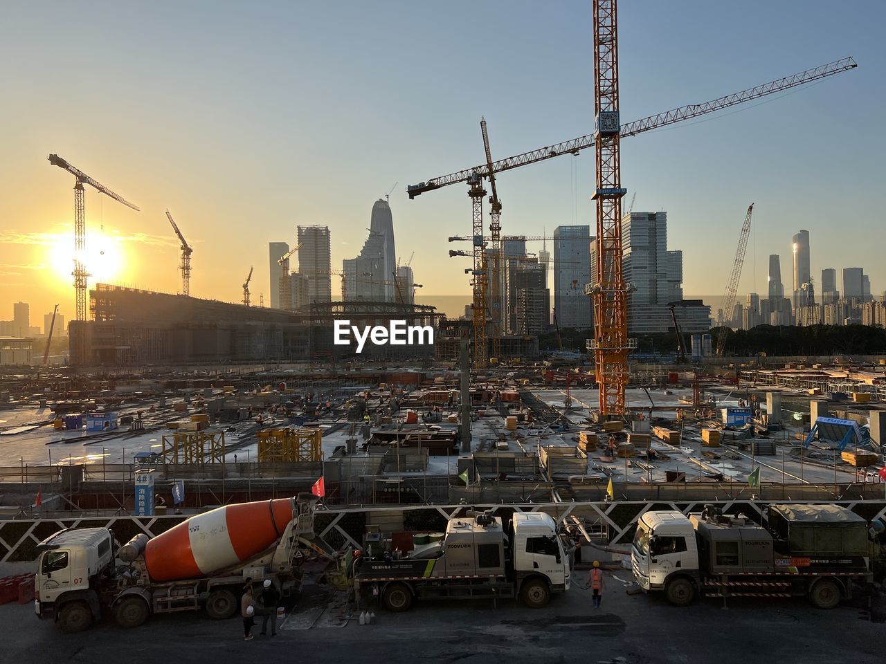 architecture, city, built structure, sky, building exterior, sunset, industry, transportation, cityscape, urban area, urban skyline, skyscraper, office building exterior, building, vehicle, crane - construction machinery, landscape, nature, business finance and industry, business, mode of transportation, construction industry, machinery, transport, skyline, development, motor vehicle, outdoors, downtown, traffic, car, no people, construction site, tower, sun, city life, road, land vehicle, sunlight, finance and economy, construction, travel destinations, dusk