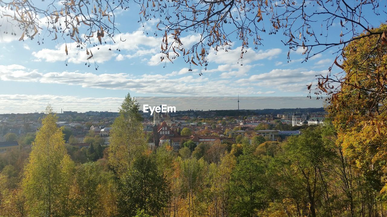 View of cityscape against cloudy sky