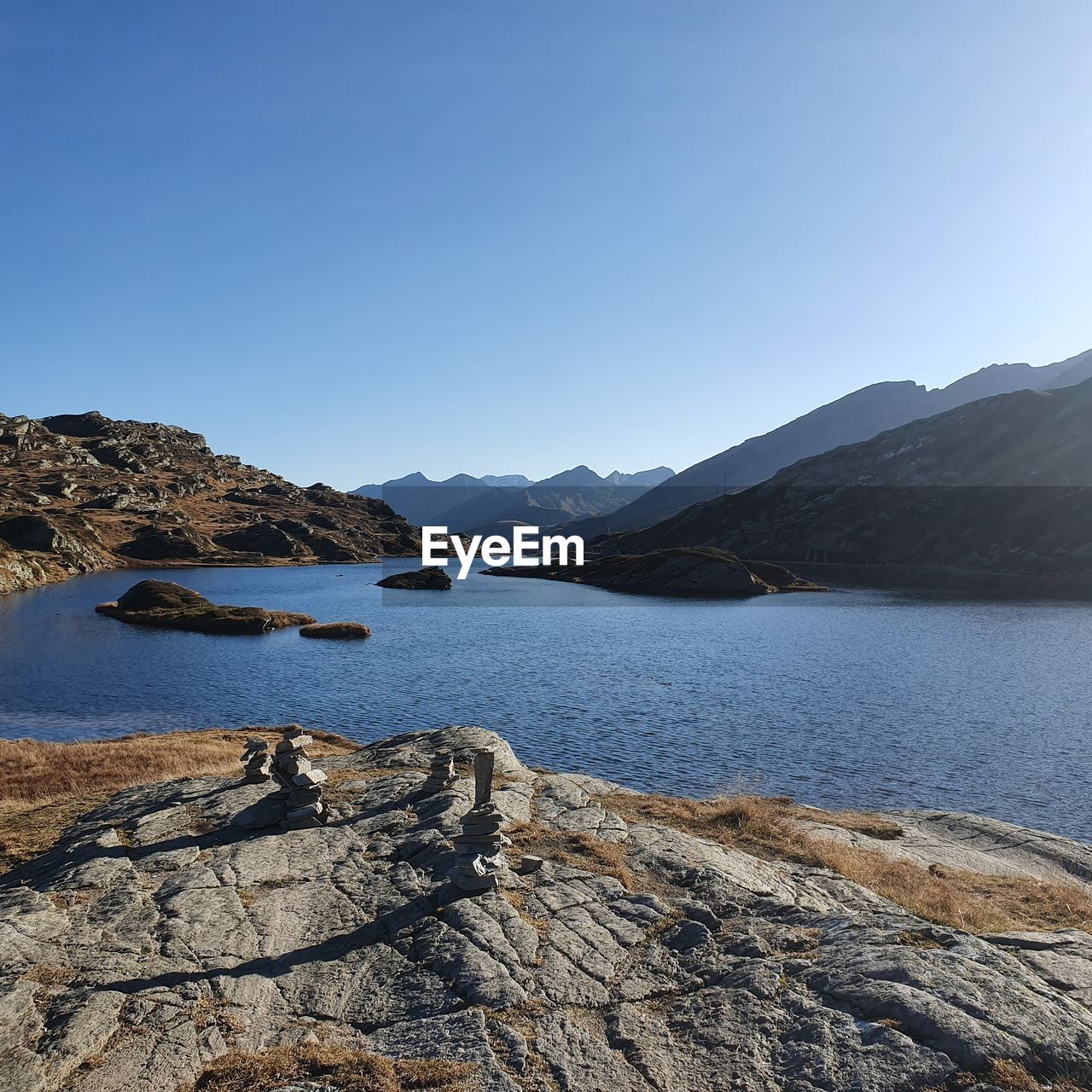 Scenic view of lake against clear blue sky