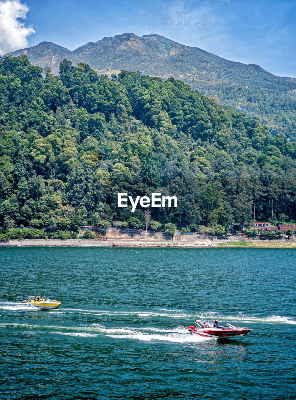 Two speedboats are passing through the sarangan lake magetan indonesia