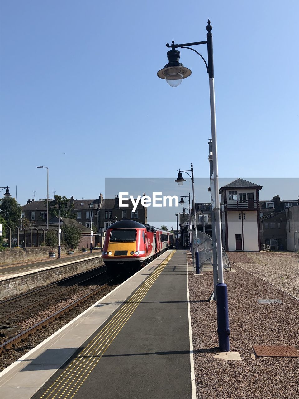 TRAIN ON RAILROAD TRACKS AGAINST SKY