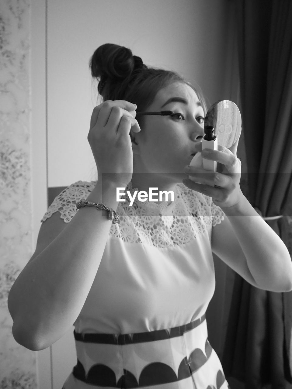 Woman doing make-up at home